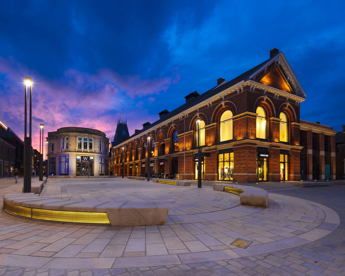 The ϹӰԺ Cornhill Quarter with lights on at night time